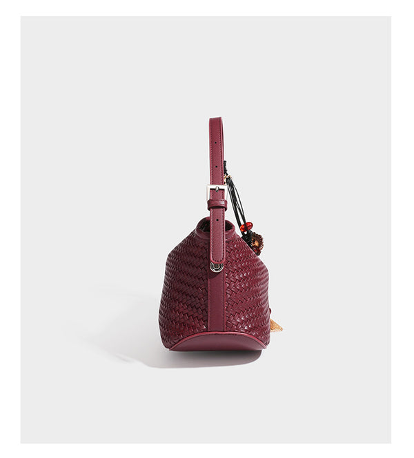 Small woven-look leather-look flap shoulder hobo bag in burgundy with silver-tone hardware and decorative tassel charm