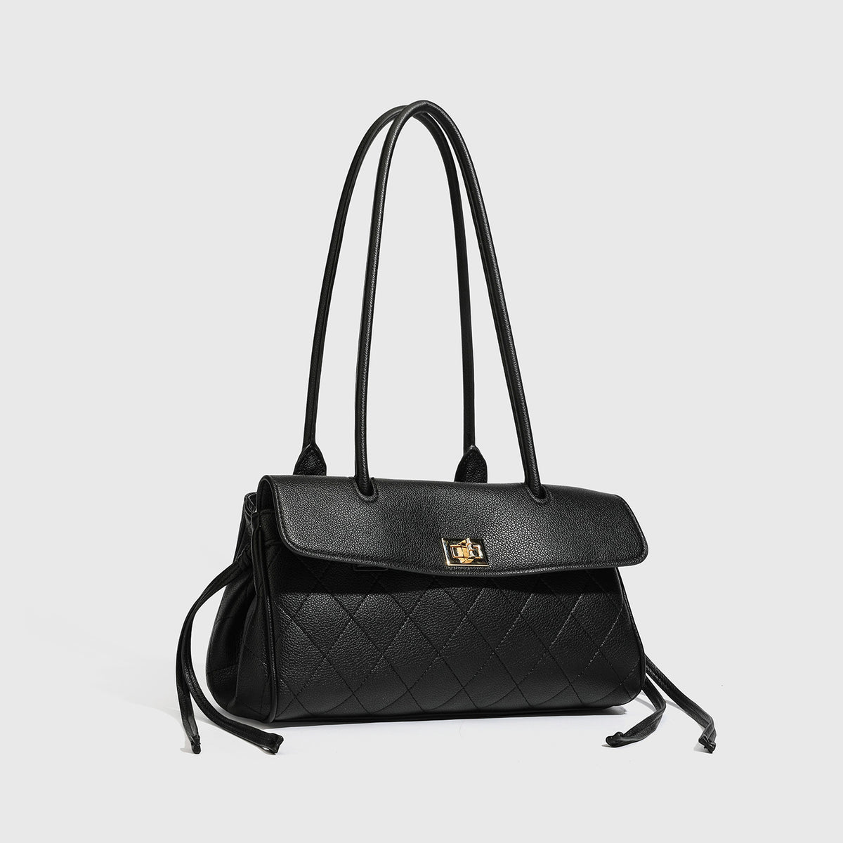 Structured black diamond-quilted shoulder bag with gold-tone turn-lock flap closure and dual round shoulder straps, detail