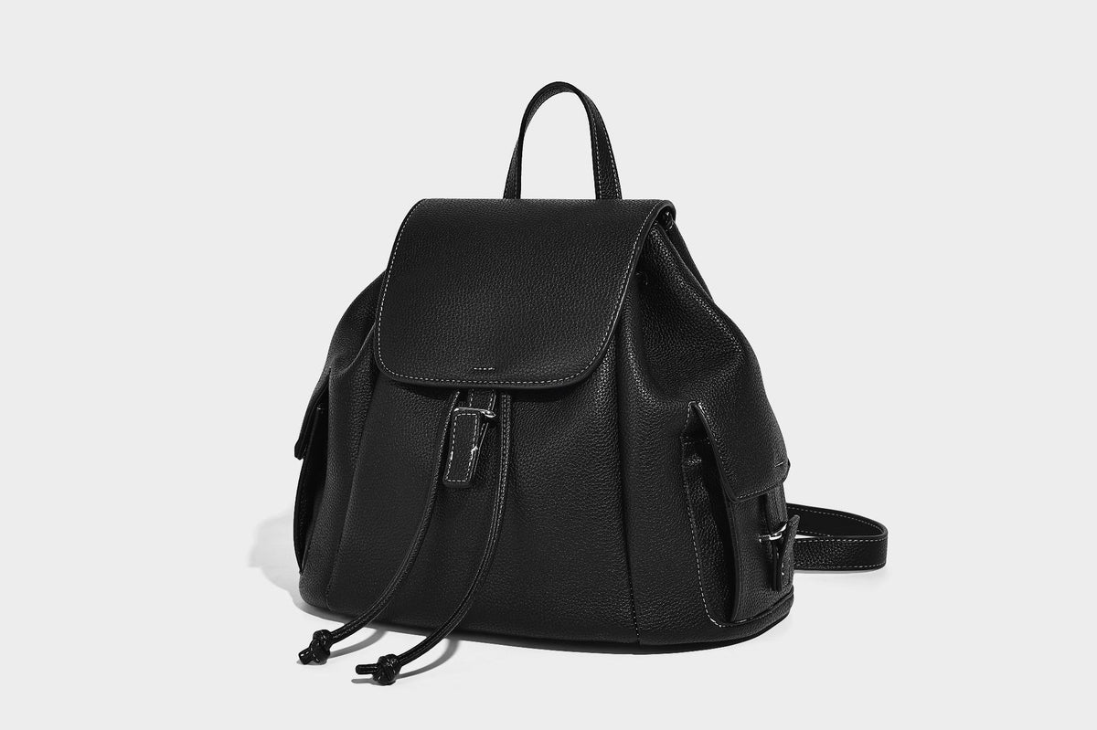 Compact pebbled leather-look flap drawstring backpack handbag with side pockets, top handle, and silver-tone hardware, detail