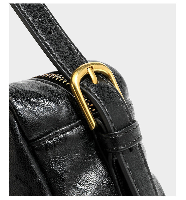 Compact black crinkled leather-look baguette shoulder bag with gold-tone arch hardware and adjustable strap, detail view 19