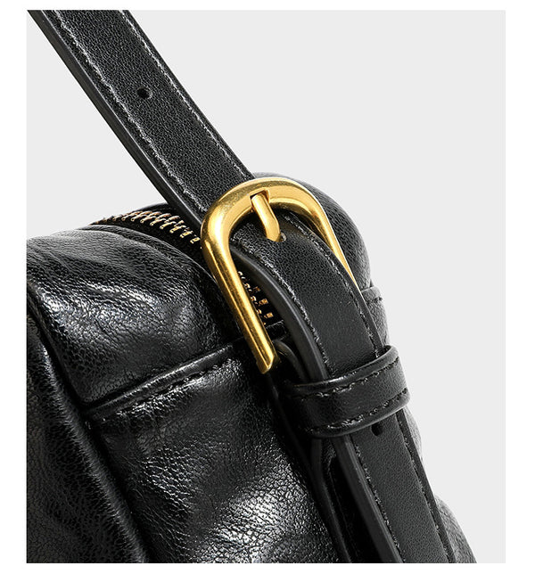 Compact black crinkled leather-look baguette shoulder bag with gold-tone arch hardware and adjustable strap, detail view 19