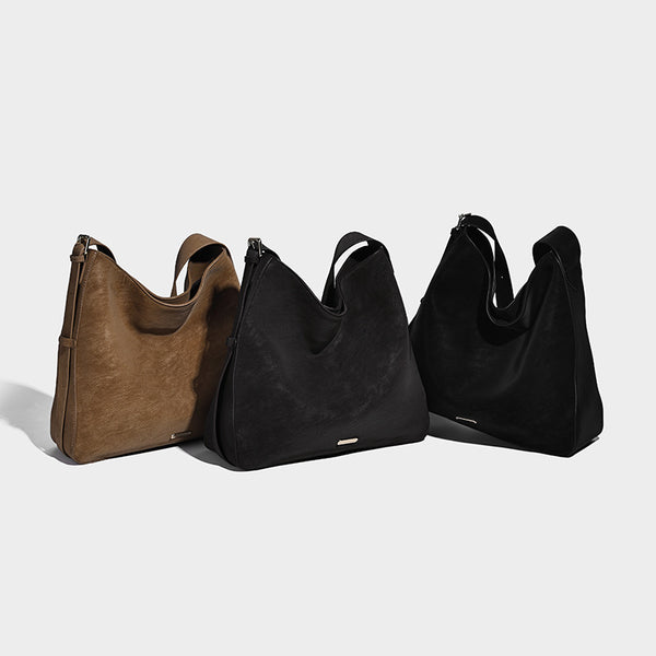 Large slouchy hobo shoulder bag in matte leather-look finish with adjustable strap and gold-tone bar hardware, detail view 2