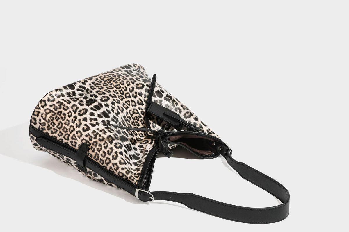 Slouchy leopard print shoulder hobo bag with black leather-look trim, tie-top closure, and single long strap, detail view 36