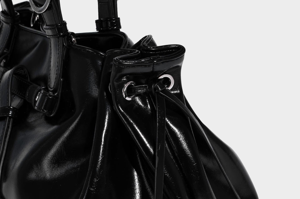 Glossy patent-look slouchy tote bag with ruched drawstring sides, dual top handles, silver ring hardware, and detachable