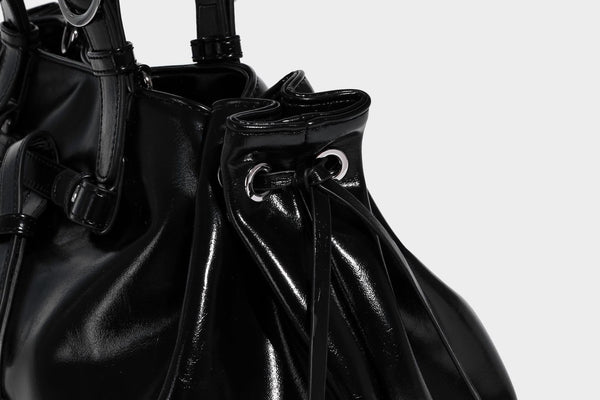 Glossy patent-look slouchy tote bag with ruched drawstring sides, dual top handles, silver ring hardware, and detachable
