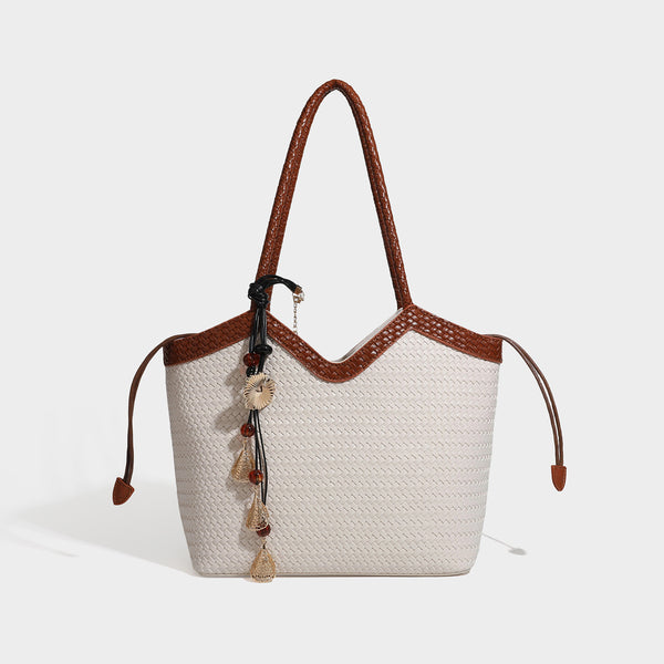 Woven tote bag with braided shoulder straps, drawstring closure, and dangling metal-and-bead charm, detail view 8