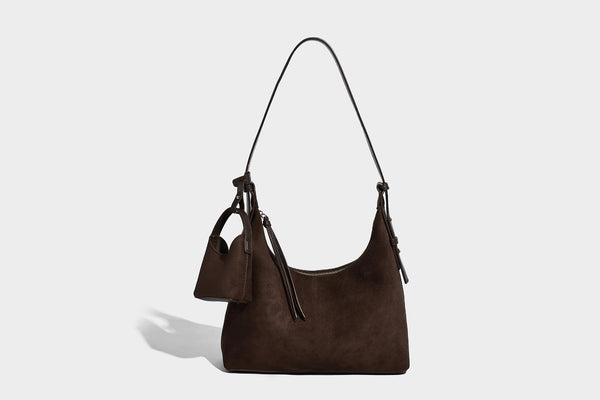 Dark brown suede-look hobo shoulder bag with top zip closure, adjustable strap, and small detachable mini pouch, detail view