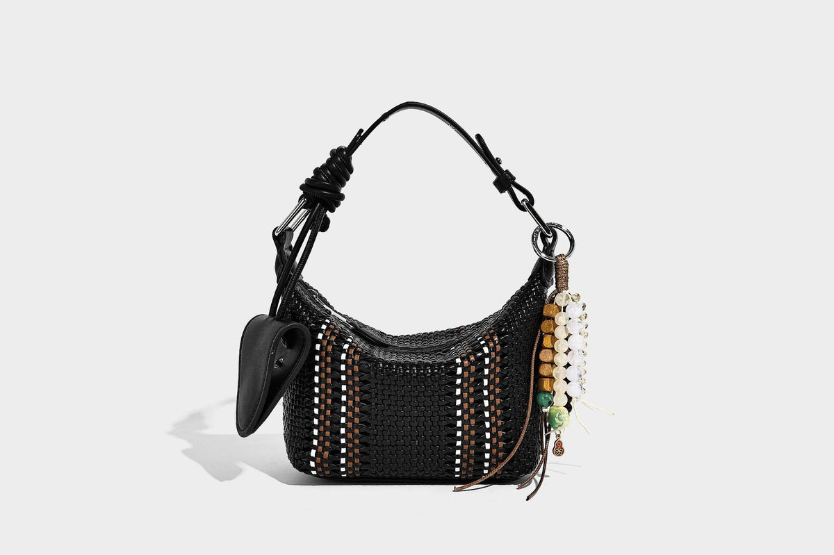 Small woven crescent shoulder bag with leather-look trim, zip closure, silver-tone ring hardware, and beaded tassel charm