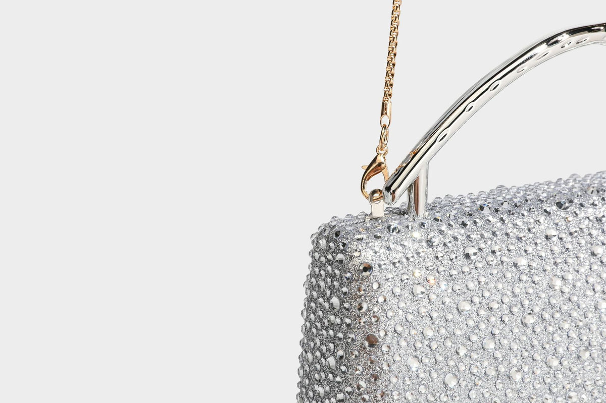 rectangular hard-case rhinestone evening clutch with sculptural gold-tone branch-and-bud top handle and detachable chain