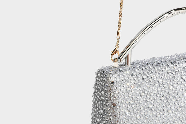 rectangular hard-case rhinestone evening clutch with sculptural gold-tone branch-and-bud top handle and detachable chain
