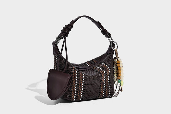 Small woven crescent shoulder bag with leather-look trim, zip closure, silver-tone ring hardware, and beaded tassel charm