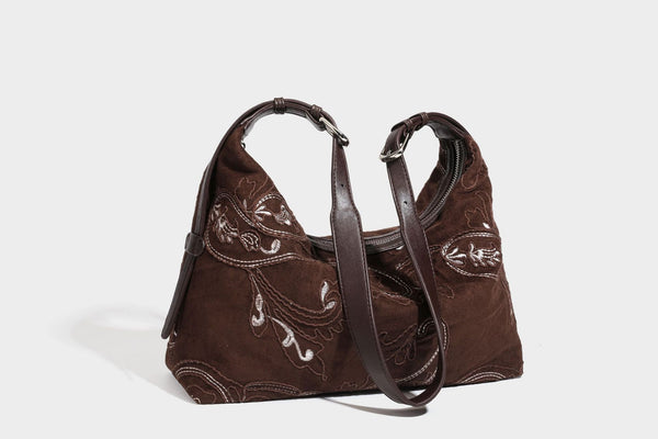 Deep chocolate suede-look hobo shoulder bag with tonal paisley floral embroidery, smooth dark leather-look trim, top zip