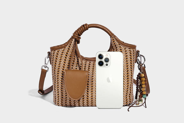 Small structured woven tote crossbody bag with ring top handle, leather-look brown trim, front patch pocket, and detachable