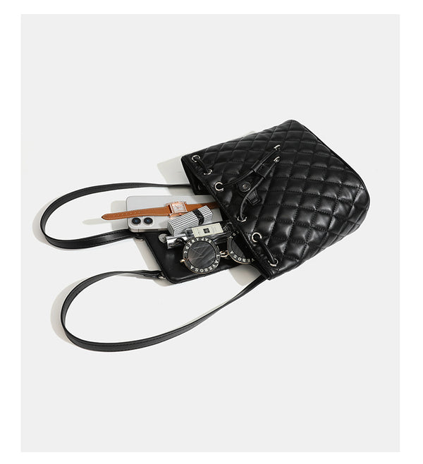 Black diamond-quilted backpack handbag with silver-tone chain flap accent and adjustable shoulder straps, detail view 22
