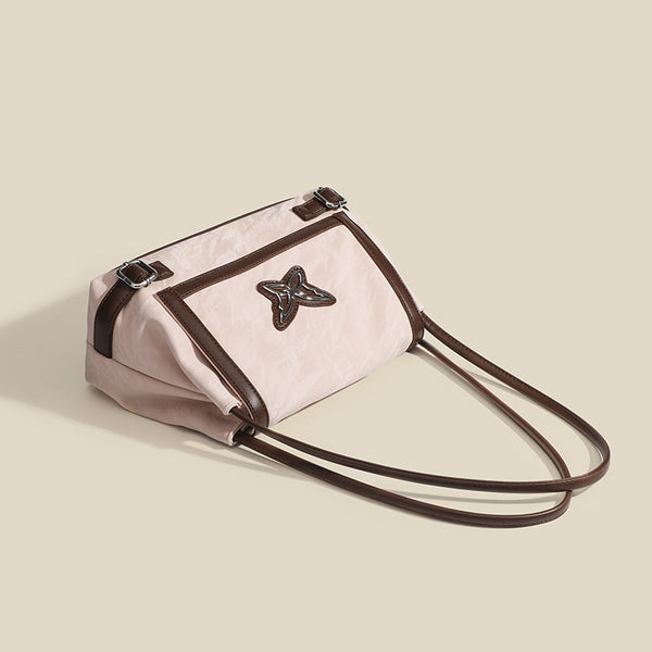 Structured crinkle-finish flap shoulder bag with butterfly metal appliqué and dark brown contrast trim, detail view 4