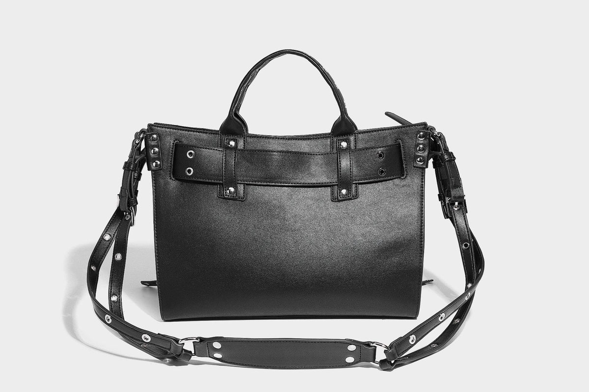 Black structured rectangular satchel bag with silver-tone rivets, large front buckle strap, zip pockets, dual top handles