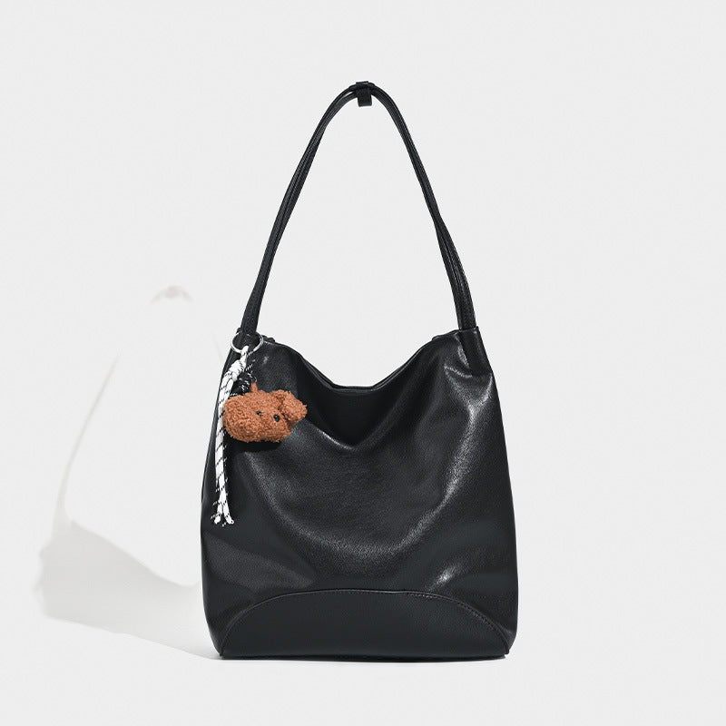Slouchy leather-look shoulder tote with bear charm tassel in black and coffee brown, detail view 6