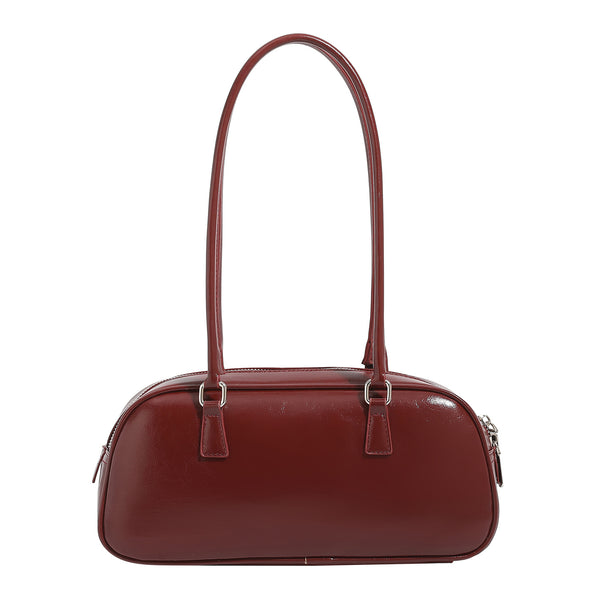 Rounded baguette shoulder bag with glossy leather-look finish, double-pull zip top, dual top handles, and silver-tone, detail
