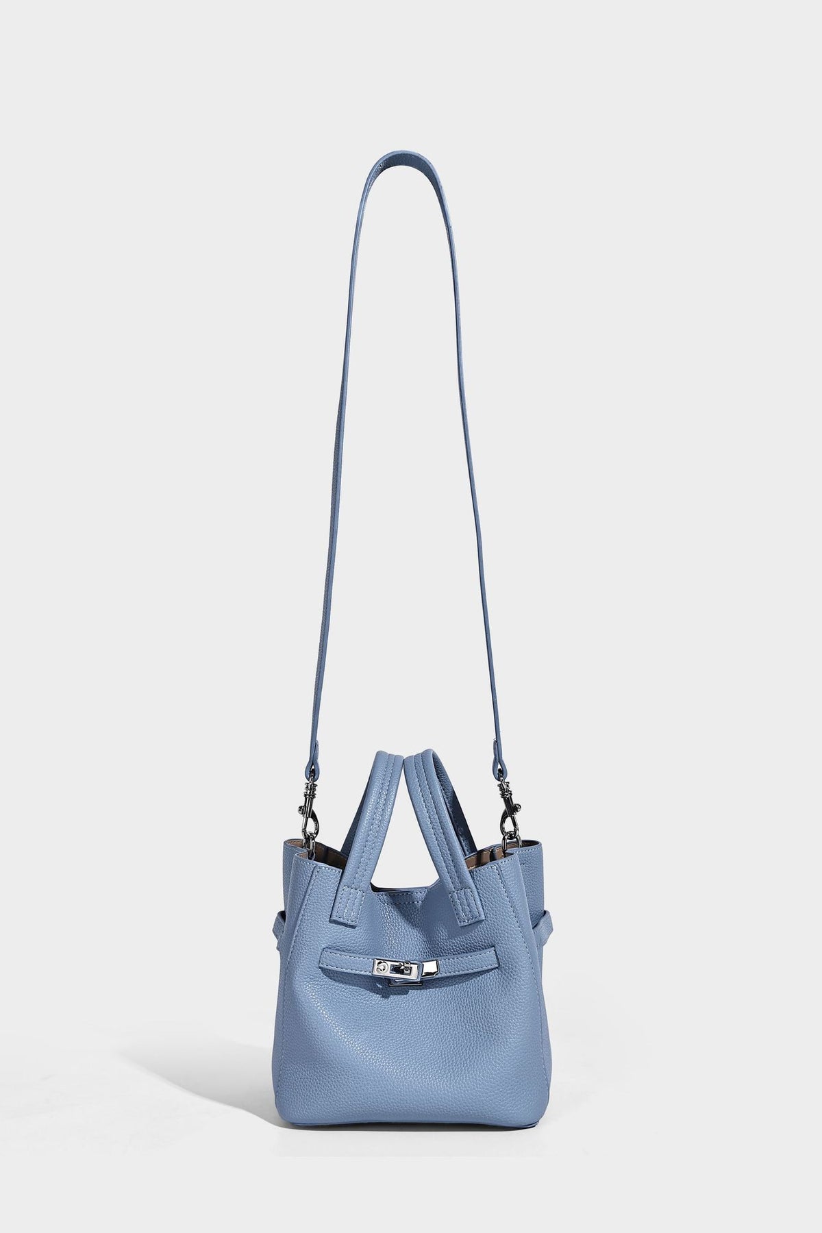 Small structured pebbled bucket tote bag with dual top handles, silver turn-lock front pocket, and detachable shoulder strap