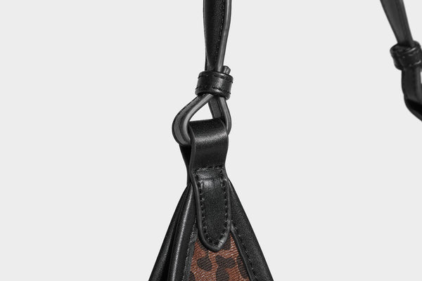 Slouchy brown leopard jacquard hobo tote bag with black leather-look trim and single shoulder strap, shown with black, detail