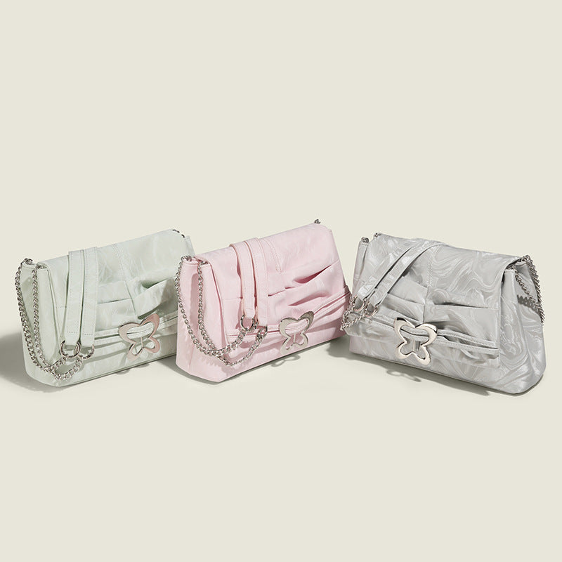 Structured rectangular chain shoulder bag with silver butterfly clasp and glossy crinkled finish, detail view 2