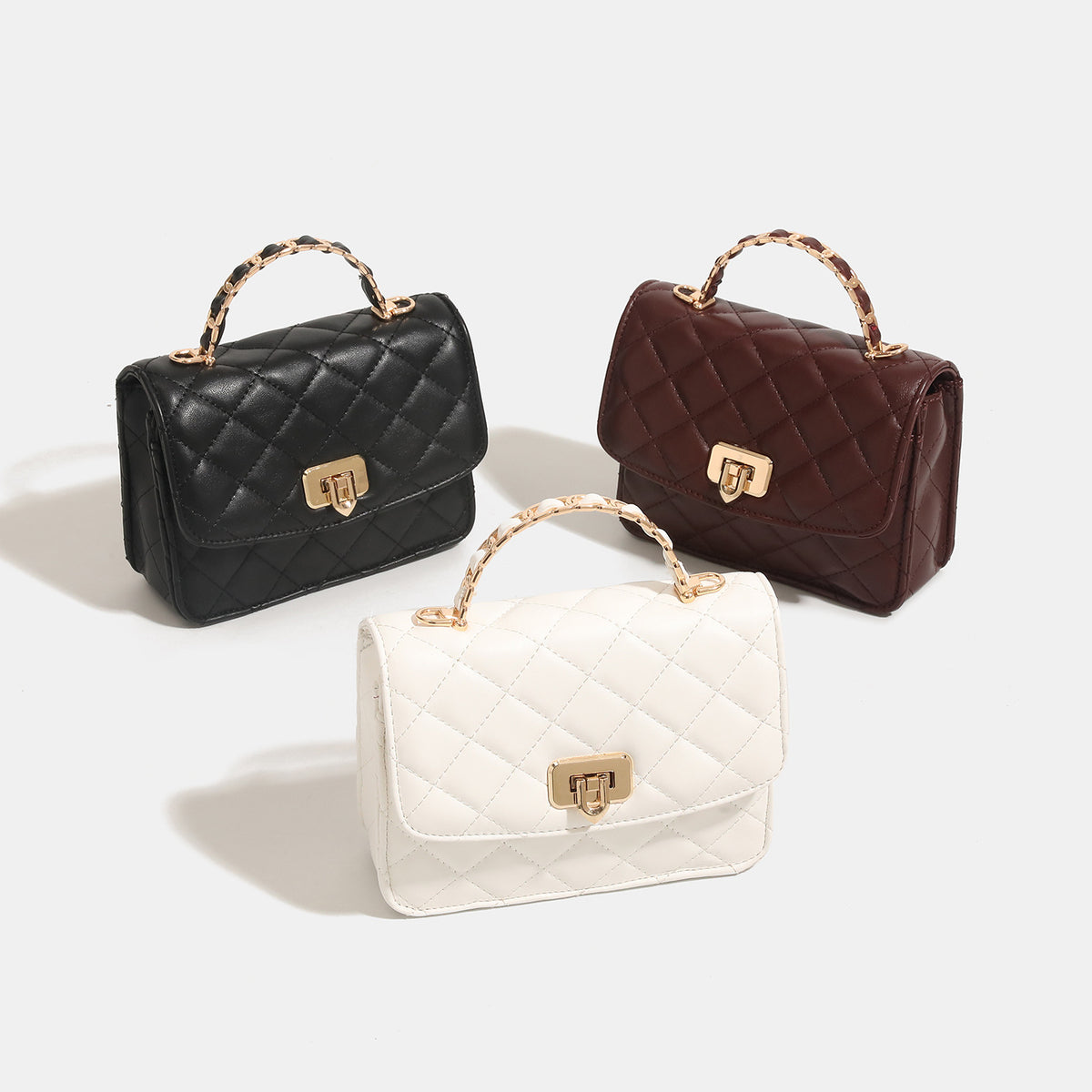 Small structured quilted flap crossbody bag with gold-tone turn-lock closure and chain strap, detail view 2