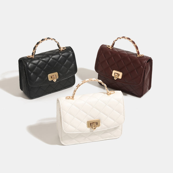 Small structured quilted flap crossbody bag with gold-tone turn-lock closure and chain strap, detail view 2