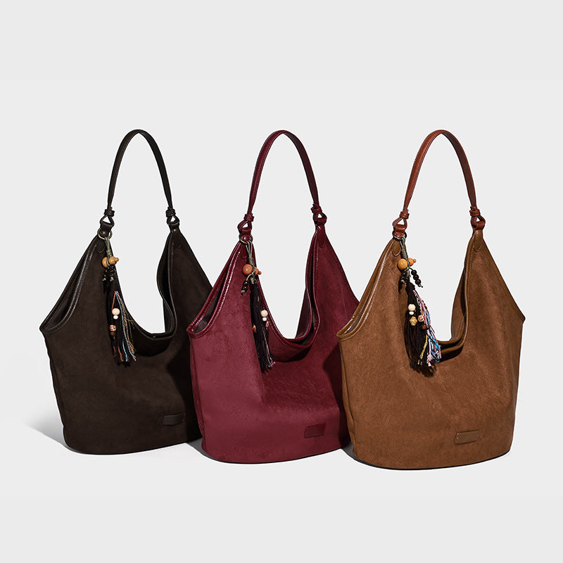 Lässig fallende Hobo-Schultertasche in matter Velourslederoptik mit offenem Überschlag und optionalem Quasten-Perlen-Anhänger, Detailansicht 2