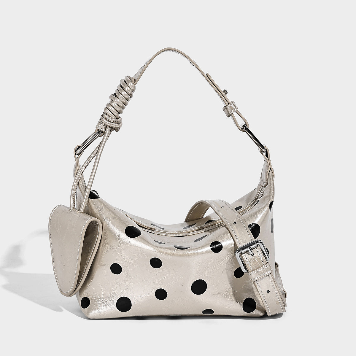 Polka-dot gloss leather-look shoulder bag with attached mini front pouch, top zip closure, and adjustable strap, front view