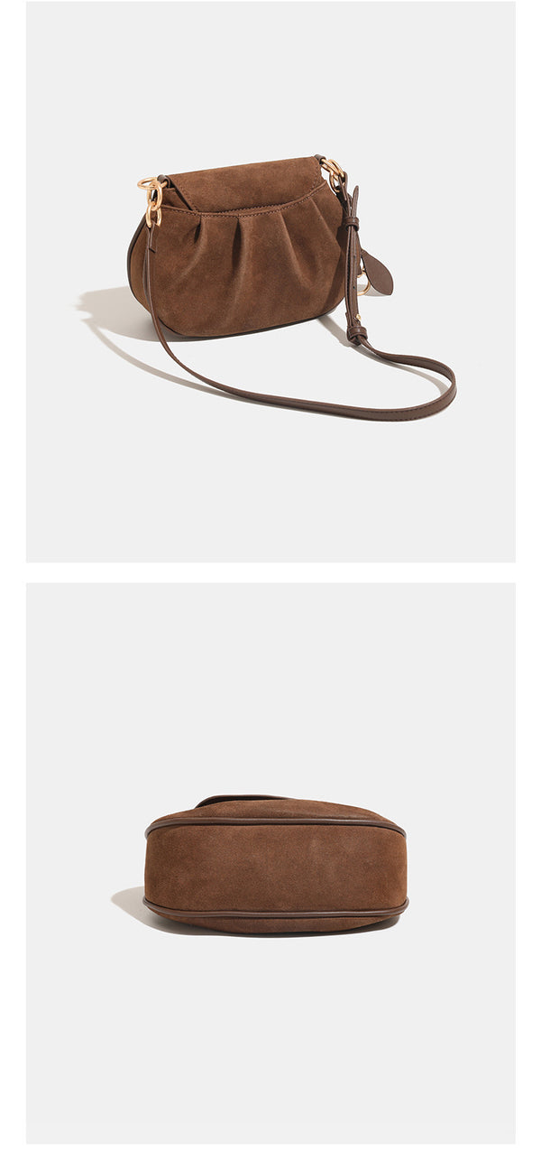 Small rounded flap crossbody saddle bag with gold-tone ring hardware and adjustable strap, detail view 13