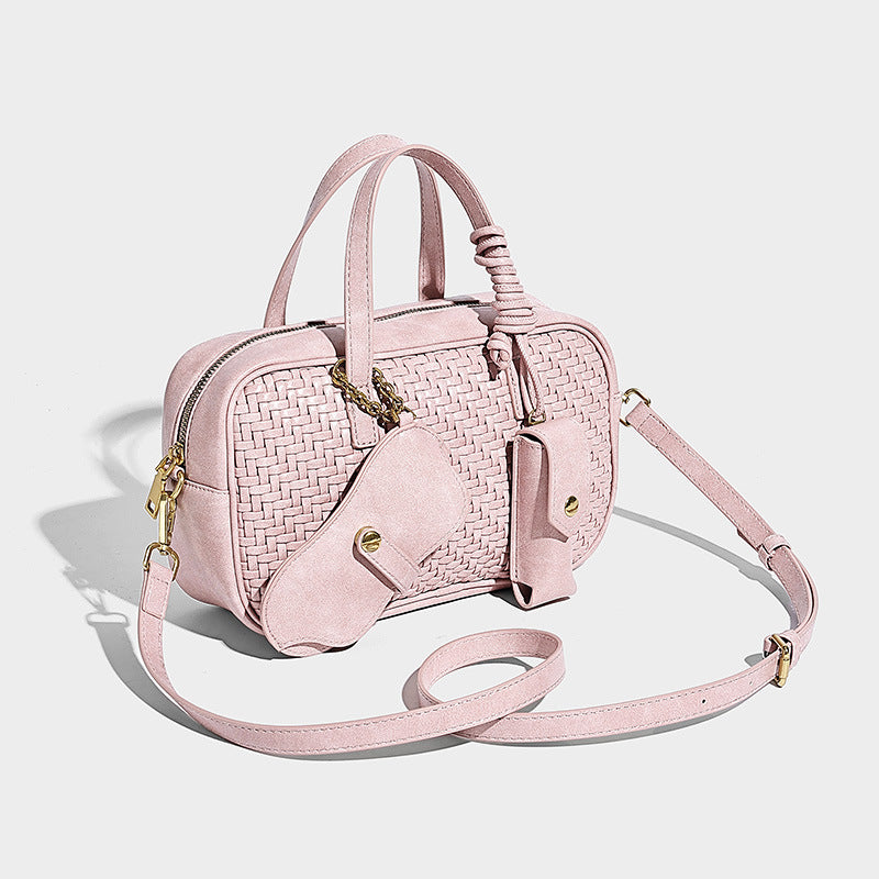Structured woven-texture Boston bag with smooth leather-look trim, dual top handles, detachable mini snap pouch, and, front