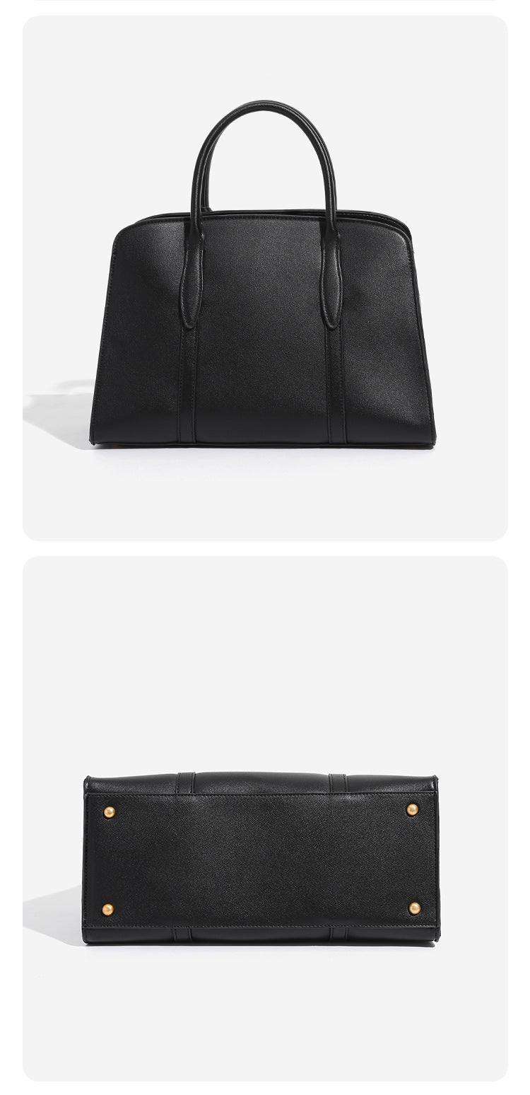 Structured trapezoid Boston satchel bag with dual top handles, gold-tone lock charm, and top zip closure, detail view 10