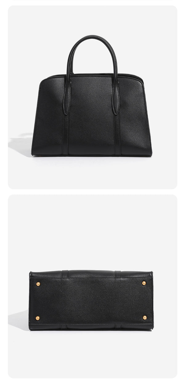 Structured trapezoid Boston satchel bag with dual top handles, gold-tone lock charm, and top zip closure, detail view 10
