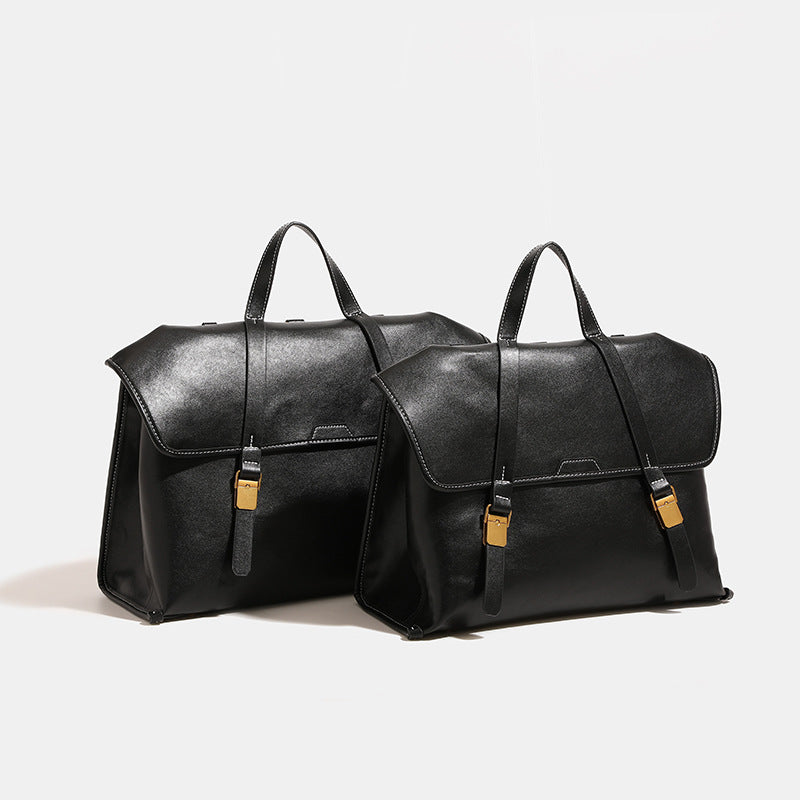 Structured flap-over backpack satchel in smooth leather-look finish with gold-tone buckle hardware and top handle, detail