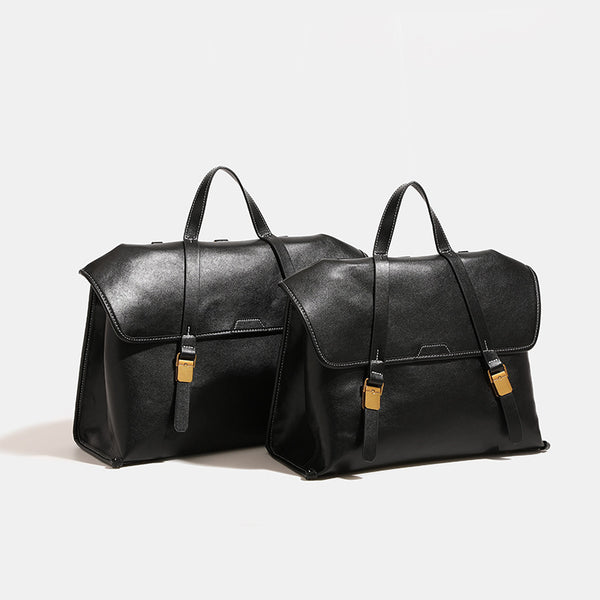Structured flap-over backpack satchel in smooth leather-look finish with gold-tone buckle hardware and top handle, detail
