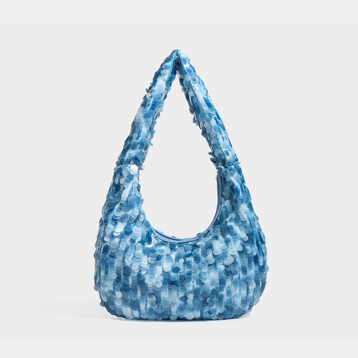Slouchy crescent hobo shoulder bag covered in overlapping reflective sequin discs with a single integrated strap and top-zip