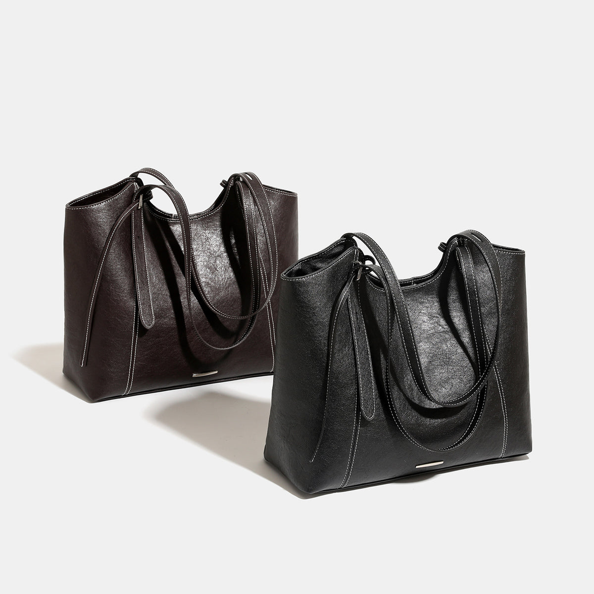 Structured open-top leather-look tote bag with long shoulder straps, contrast stitching, and side tie details, detail view 2