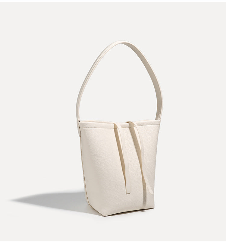Mini tapered bucket bag in pebbled leather-look finish with front tie straps and single shoulder strap, detail view 15