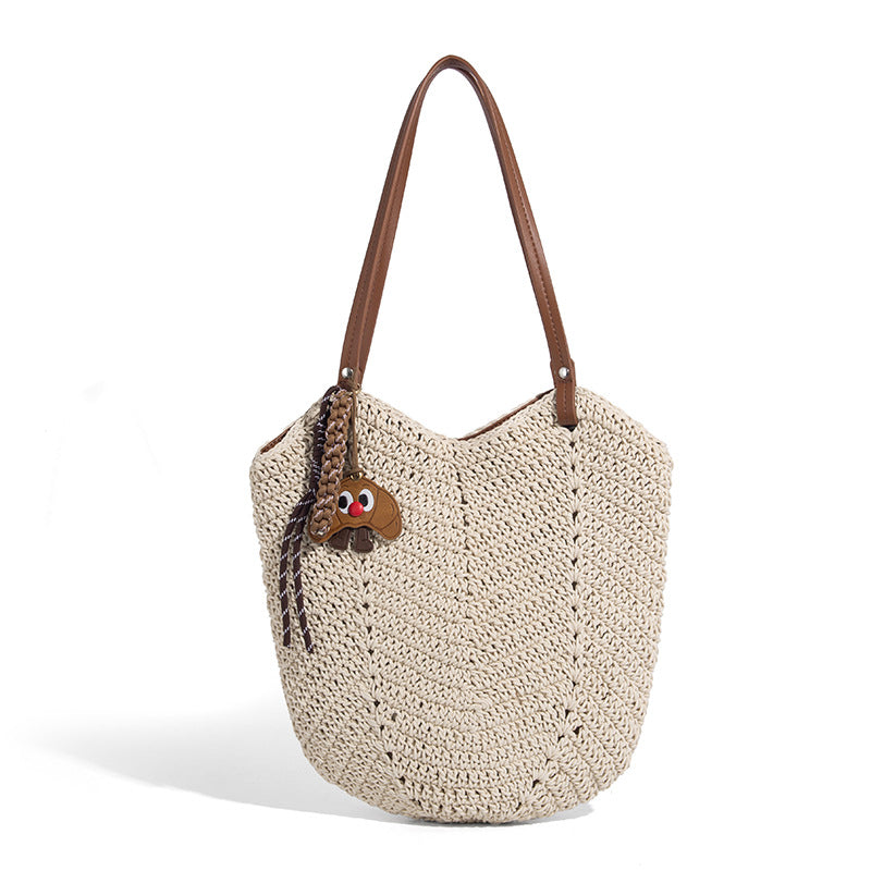 Woven crochet open-top shoulder tote bag with slim brown leather-look straps and braided charm accent, detail view 5