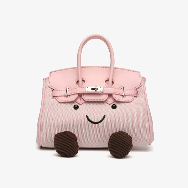 Small structured trapezoid satchel bag with smiling face motif, pom-pom accents, brown leather-look trim, silver-tone, front