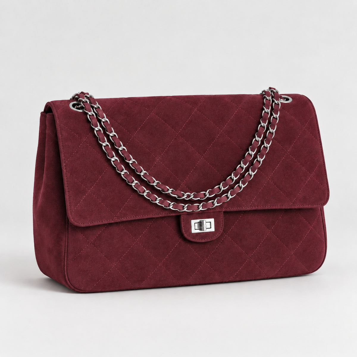 Quilted diamond-stitch flap shoulder bag with double silver chain strap and turn-lock closure in suede-look finish, detail