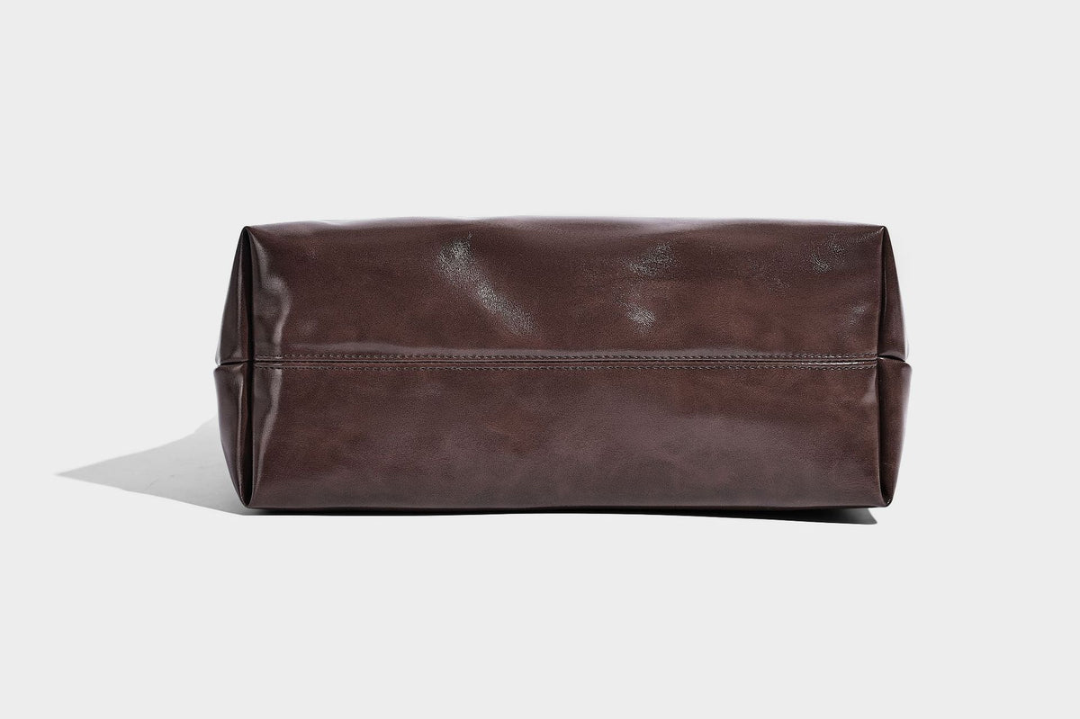 Glossy oil-wax leather-look open-top tote shoulder bag with embossed circular logo and long double straps, detail view 28