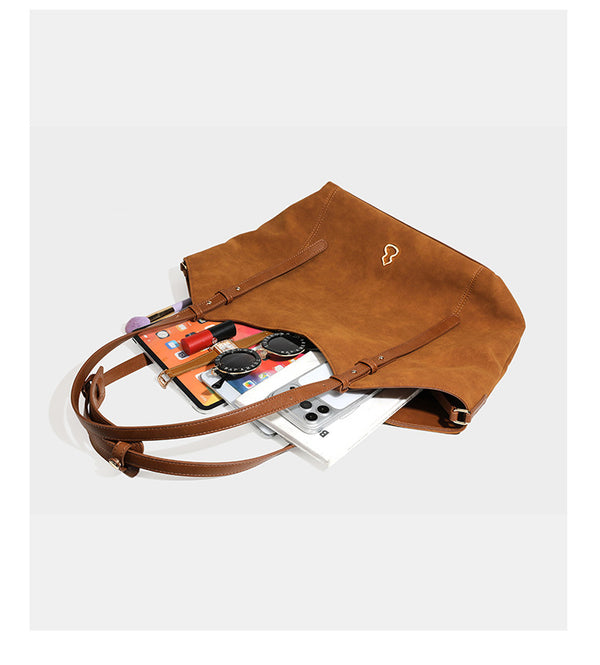 Oversized suede-finish tote shoulder bag in caramel brown with slim leather-look straps and gold-tone logo hardware, detail