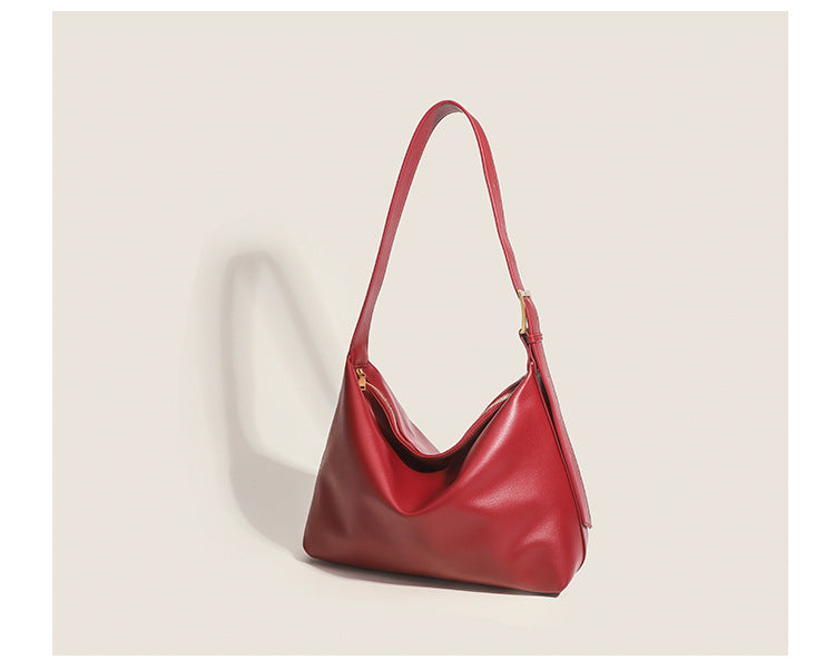 Large slouchy hobo shoulder bag in smooth leather-look finish with single long strap and gold-tone zip closure, detail view