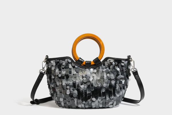 Small sequin half-moon handbag with circular wood-look ring handles and detachable leather-look shoulder strap, detail view