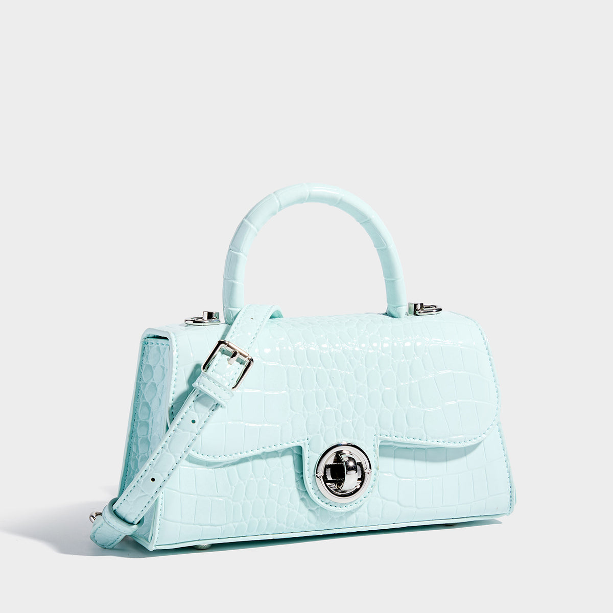 Mini croc-embossed glossy structured handbag with silver-tone turn-lock clasp and short top handle, detail view 3
