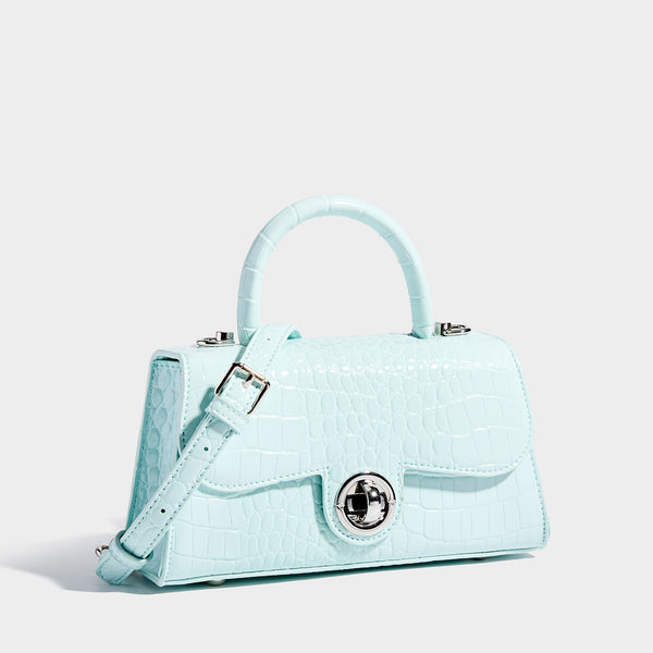 Mini croc-embossed glossy structured handbag with silver-tone turn-lock clasp and short top handle, detail view 3