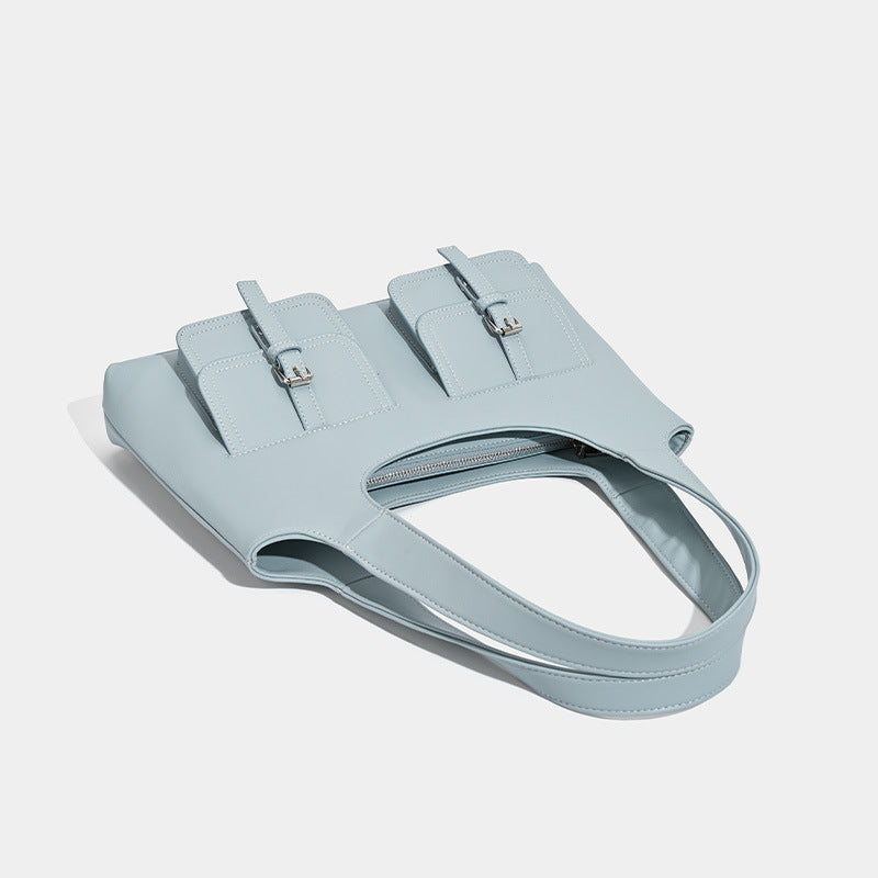 Powder blue structured tote bag with dual front flap buckle pockets and silver-tone hardware, detail view 3