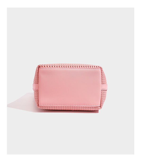 Large structured woven tote bag with striped basket-weave finish, long shoulder straps, and detachable mini pouch charm