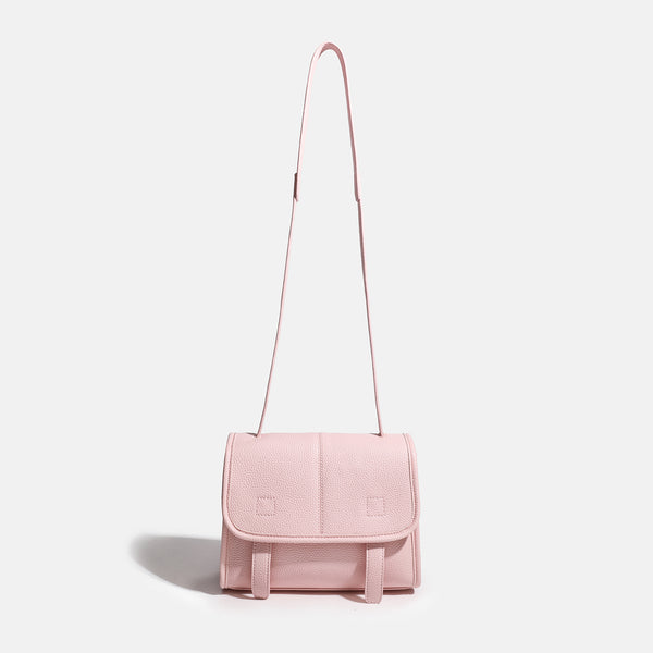 Compact structured flap satchel bag with pebbled texture, snap closure, front strap tabs, and long adjustable crossbody